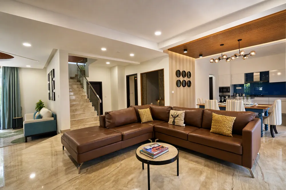 Living room with leather sofa and marble floor in the Phase 1 model villa